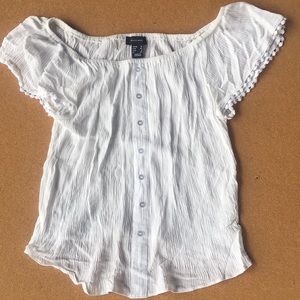 Off the shoulder white short sleeve shirt.